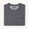 Close-up of folded heather charcoal gray t-shirt with black embroidered DC logo on the corner