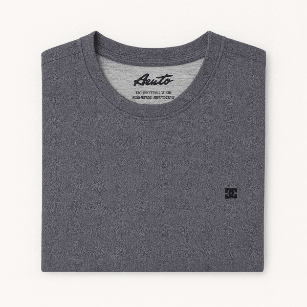 Close-up of folded heather charcoal gray t-shirt with black embroidered DC logo on the corner