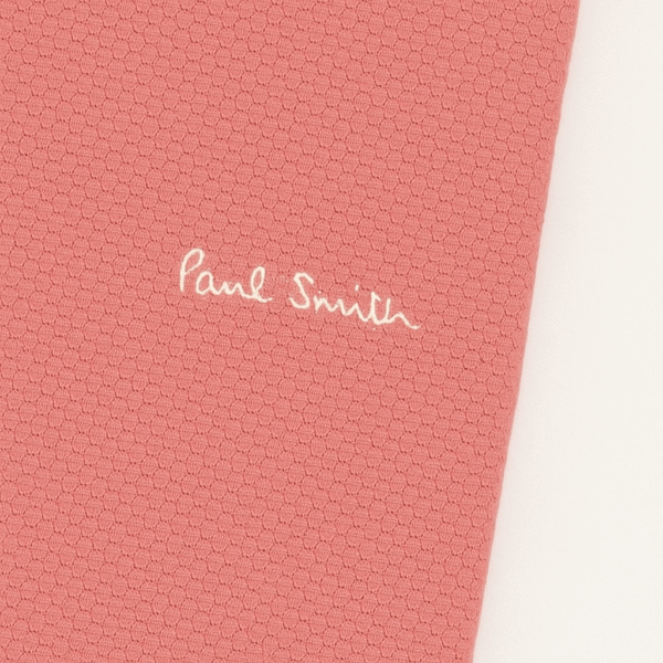 Folded Paul Smith terracotta polo shirt with embroidered logo and button placket