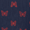 A navy blue short-sleeved girl’s frock with red butterfly print and a gathered skirt.