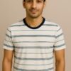 Folded cream crewneck T-shirt with navy and mint horizontal stripes and dark neckline