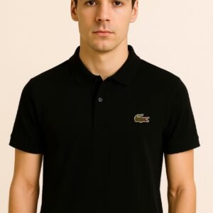Folded black Lacoste polo shirt with green crocodile logo and white label text