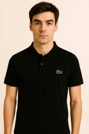 Folded black Lacoste polo shirt with green crocodile logo and white label text