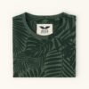 Man wearing an olive green T-shirt with all-over tropical leaf print