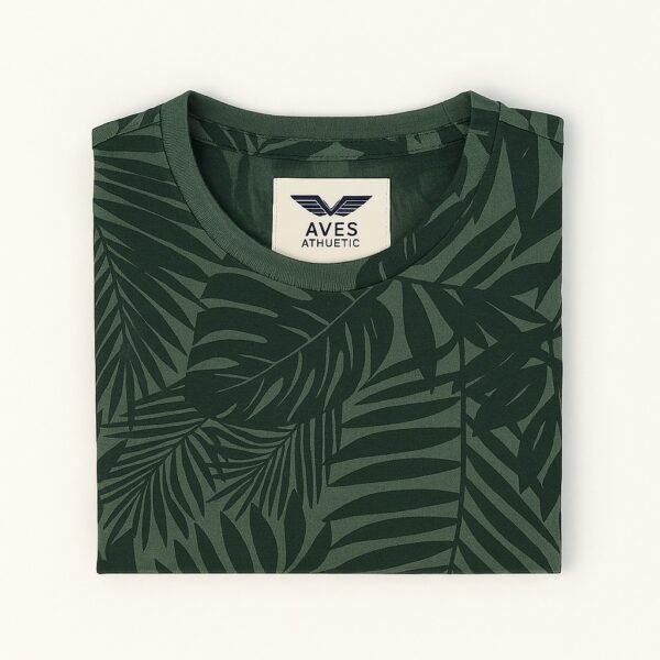Man wearing an olive green T-shirt with all-over tropical leaf print