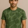 Man wearing an olive green T-shirt with all-over tropical leaf print