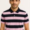 Folded black and pink horizontal striped polo shirt with black collar and button placket