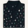 Man wearing navy blue polo shirt with Christmas-themed snowman, candy cane, snowflake, and tree patterns