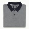 Folded grey polo shirt with small white geometric dot pattern and navy blue collar.