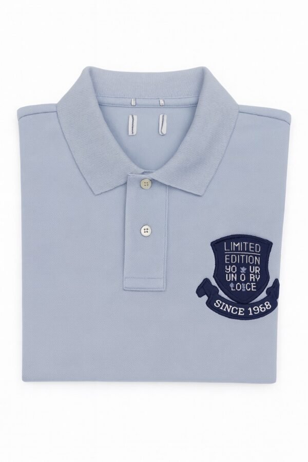 Folded light blue polo shirt with embroidered "Limited Edition Since 1968" crest on chest