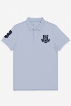 light blue polo shirt with embroidered "Limited Edition Since 1968" crest on chest.