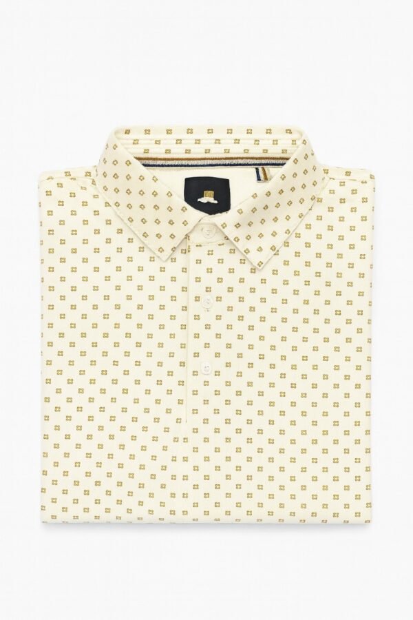 Short-sleeved off-white polo shirt with gold geometric print laid flat on white background.