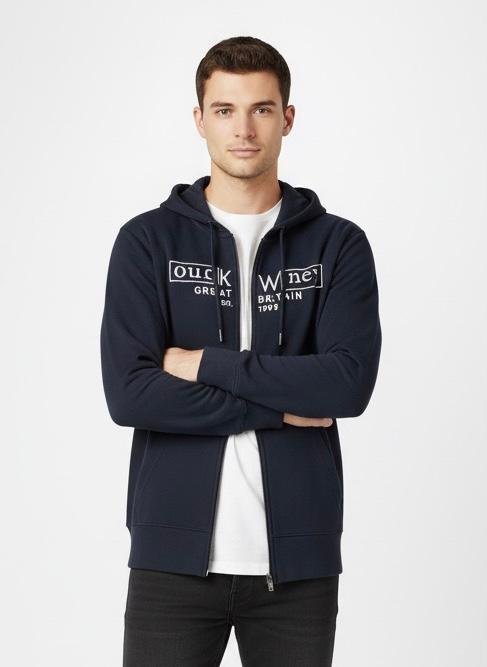 Men’s Navy Blue Zip-Up Hoodie with Logo Print Man wearing a navy blue zip-up hoodie with white printed logo, white t-shirt underneath, and black jeans, standing with arms crossed against a plain white background.