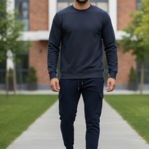 Navy blue ribbed sweatshirt hanging on a black velvet hanger with a gold hook in a modern clothing store, surrounded by soft blue and white lights.