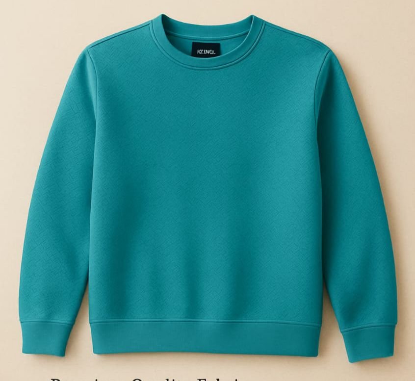 Teal green plain crew neck sweatshirt on wooden hanger in modern clothing store.