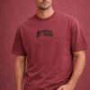 Men wearing maroon crew neck t-shirt with “OFFICIAL” printed on the chest, casual half sleeve cotton t-shirt with minimal design.