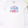 Young girl wearing a white half sleeve t-shirt with “Pretty Girl” colorful butterfly graphic design