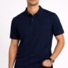 Man wearing a dark navy blue short sleeve polo shirt with classic collar and button placket